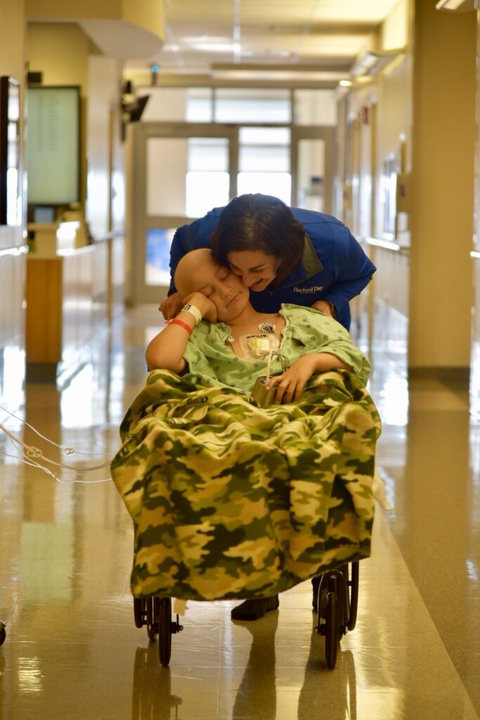 Mom embracing child who is apart of the Believe In Tomorrow program