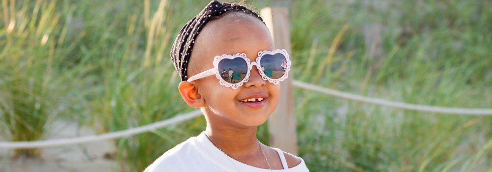A smiling girl in the Believe In Tomorrow Charity program