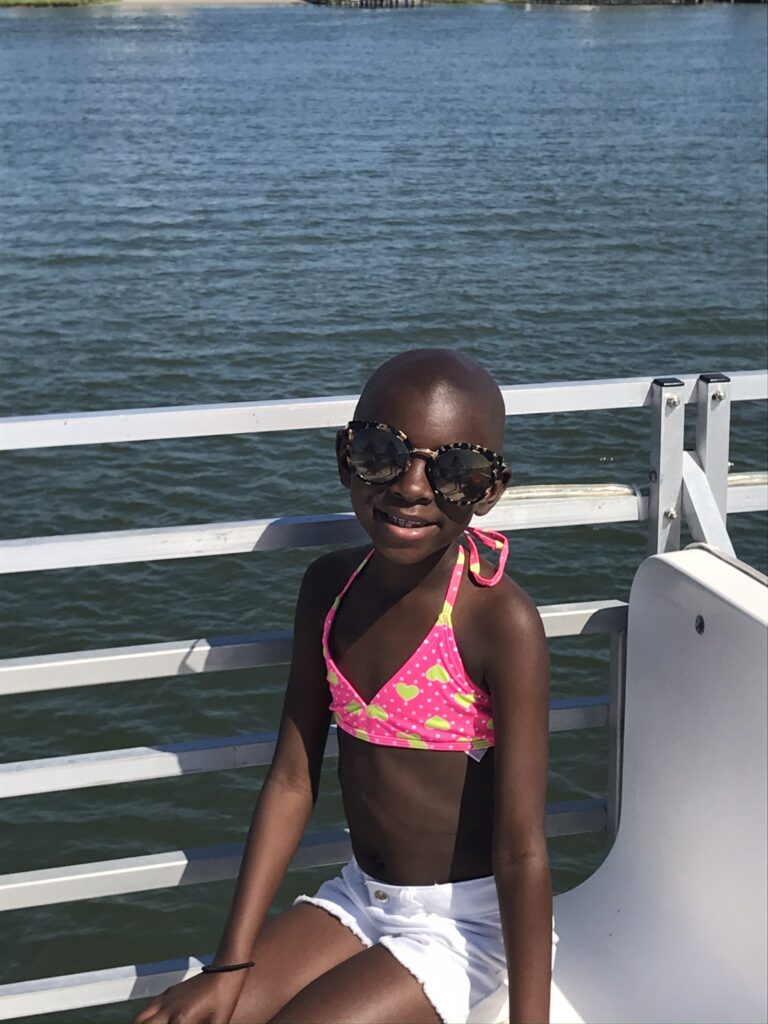 Young girl smiling while enjoying a Believe In Tomorrow respite trip