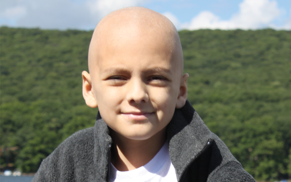 A young boy smiling while enjoying Believe In Tomorrow Children's Foundations Programs