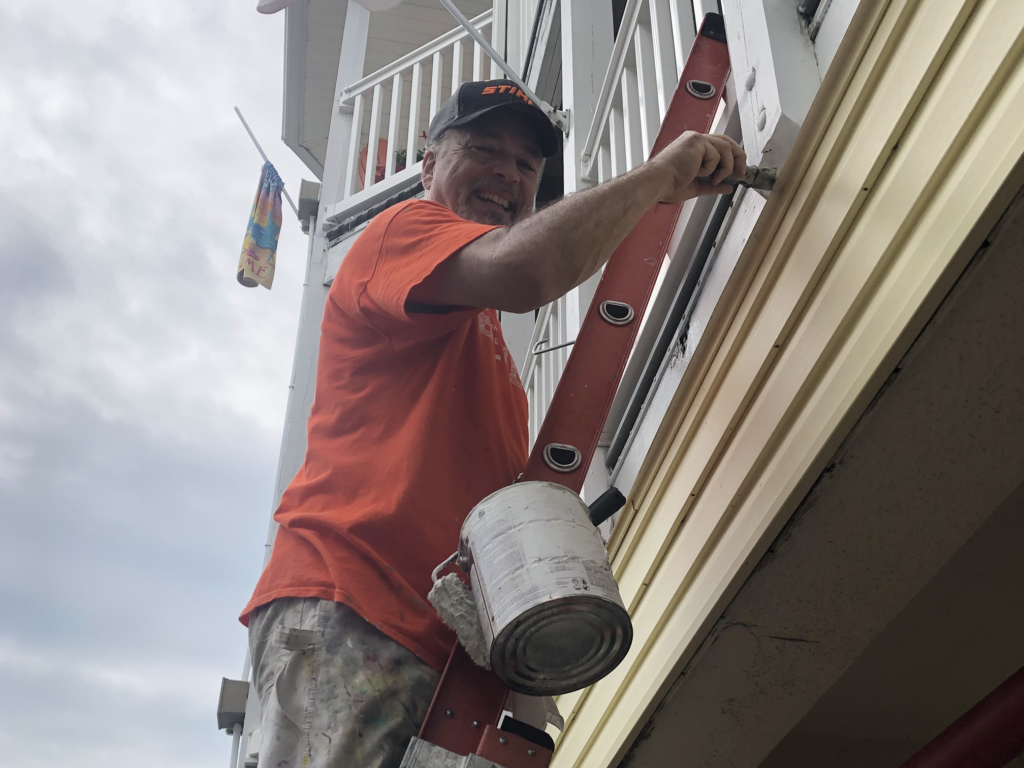 Volunteer painting at Believe In Tomorrow beach properties