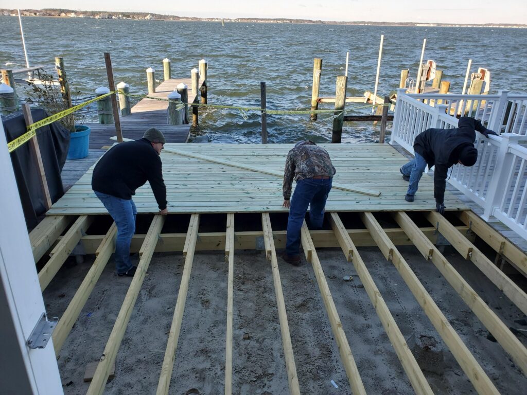 Believe In Tomorrow Corporate Partner The Home Depot building the desck on the house on the bay