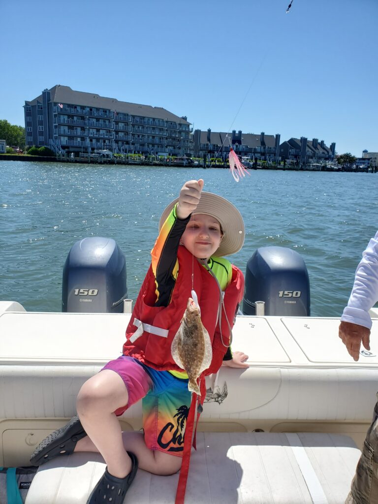 A young on a fishing trip with Believe In Tomorrow Children's Foundation
