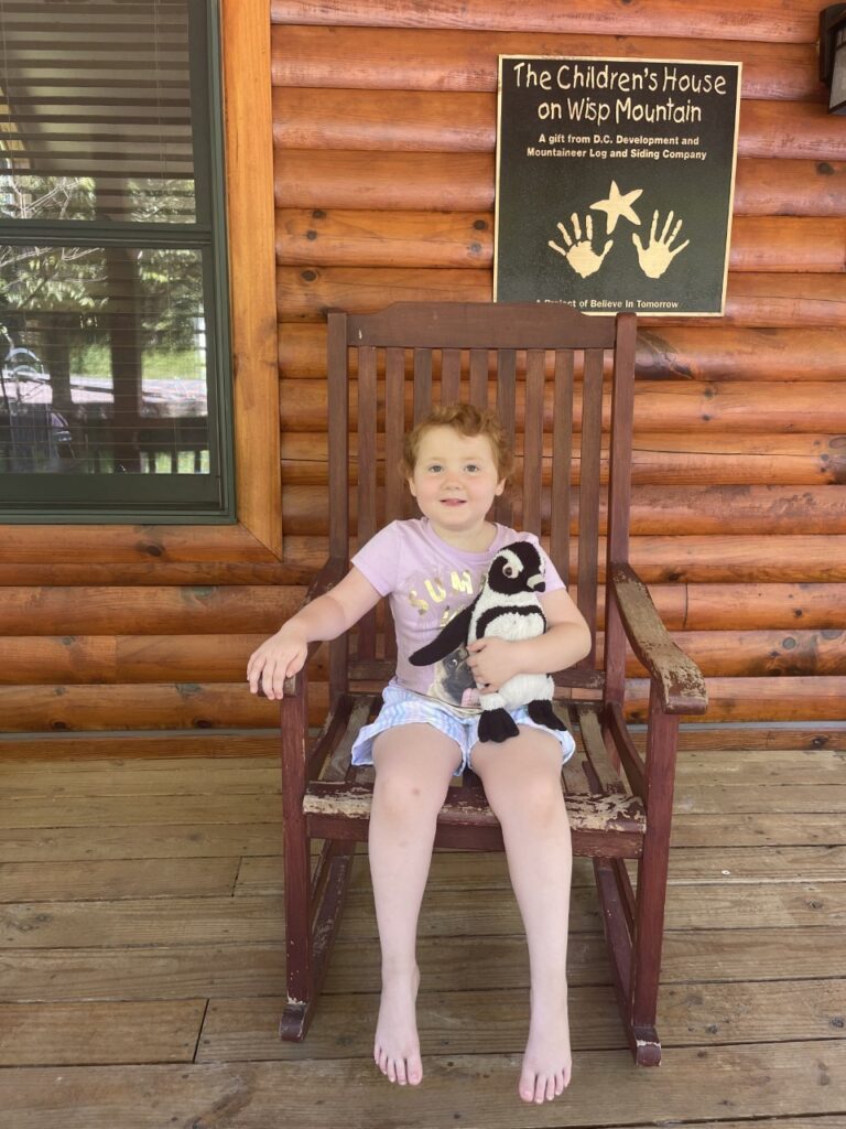 Zoey sitting in a rocking chair featured in our stories
