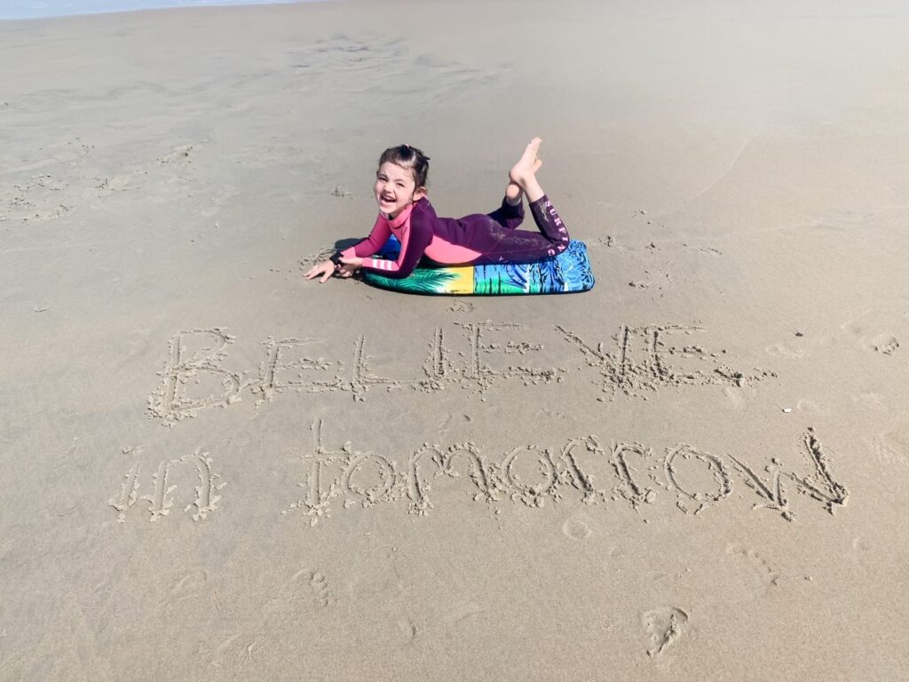 A young girl enjoying her Believe In Tomorrow respite at the beach